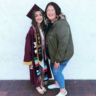 AJ and graduate celebrating at commencement ceremony