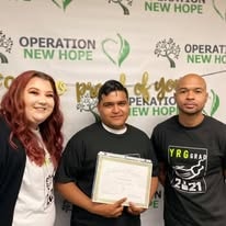 Three people celebrating at Operation New Hope YRG 2020 graduation