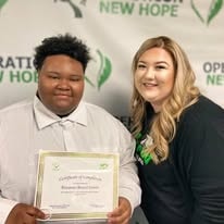 Two people posing with certificate at YRG 2021 graduation Operation New Hope