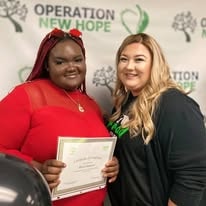 Two people posing with certificate at YRG 2021 graduation Operation New Hope