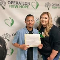 Two people posing with certificate at YRG 2021 graduation Operation New Hope