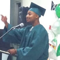 Zac, Class of 2013, delivering graduation speech at podium